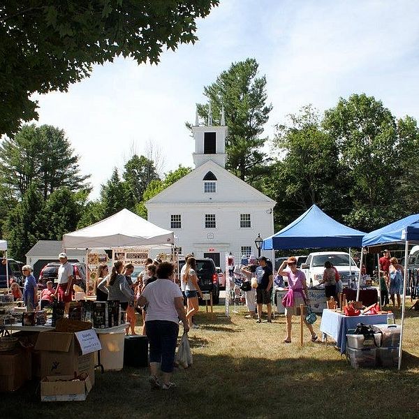 People walk through the booths at the Hebron Fair
